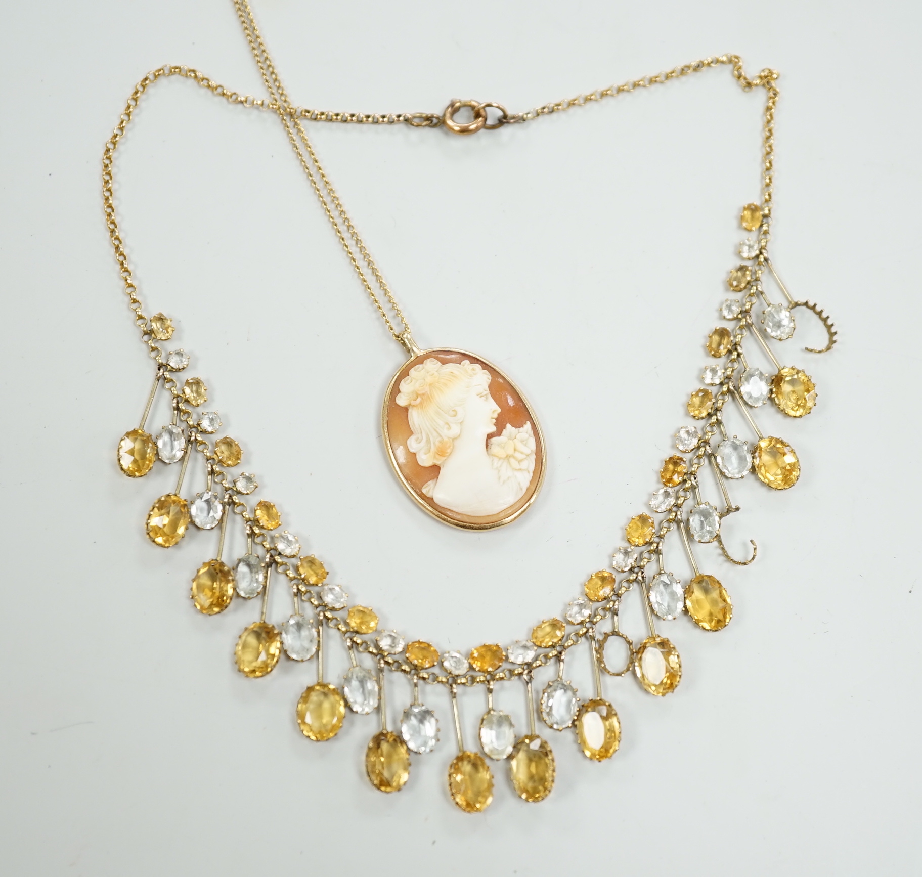 A yellow metal mounted oval cameo shell pendant, on a 9ct chain, together with a citrine and colourless beryl? set drop fringe necklace(a.f.).